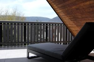 a bed on a balcony with a view of the mountains at Bonnavista Ferienwohnungen in Großheubach