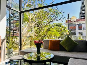a living room with a couch and a glass table at MUN HOMESTAY in Hue