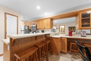 a kitchen with wooden cabinets and a counter top at Dog-Friendly Quiet Cove Condo in Hollister