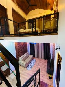 a living room with a couch and a balcony at Neems paradise in Point Pedro