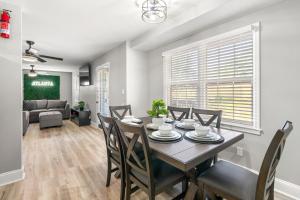a dining room and living room with a table and chairs at Opulent Haven Retreats by Deity Villas in Atlanta