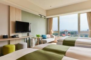 Habitación de hotel con 2 camas y TV de pantalla plana. en Aspire Resort en Longtan