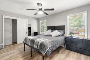 a bedroom with a bed and a ceiling fan at Opulent Haven Retreats in Atlanta