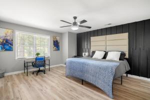 a bedroom with a bed and a desk and a ceiling fan at Opulent Haven Retreats by Deity Villas in Atlanta