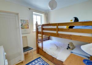 a bedroom with two bunk beds with a stuffed animal at Pebblesea in Whitstable
