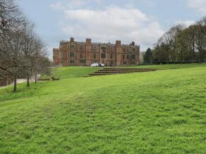 a large building on top of a green field at Cosmic Pearl in Garforth