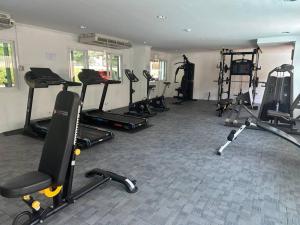 a gym with a bunch of treadms and machines at Condo Joe in Central Hua Hin in Hua Hin