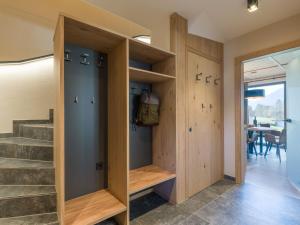 a room with wooden cabinets and a staircase at Chalet in Mariastein Hohe Salve with mountain view in Mariastein