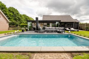 a swimming pool in the backyard of a house at Brabants Genieten in Kaatsheuvel