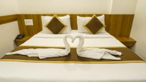 A bed or beds in a room at Sepoy Elite By Yuvraj Group of Hotels
