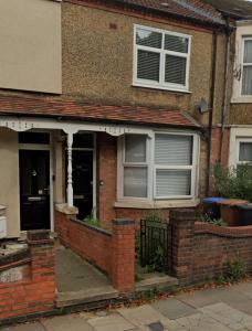 a brick house with a window and a door at Spencer bridge Rooms by AFL in Northampton