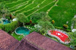 an aerial view of a garden with a swimming pool at Wooden Ganeca Villas by Pramana Villas in Ubud