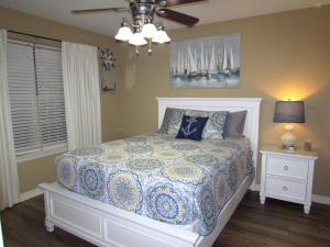 a bedroom with a bed and a lamp and a window at Lakefront Condo A-3 in Hollister