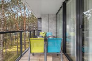 a balcony with a table and two chairs at Apartament Relax z Balkonem Shellter Rogowo Renters Prestige in Rogowo