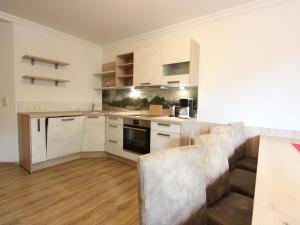 a kitchen with white cabinets and a counter top at Modern Apartment in Fieberbrunn with Terrace in Fieberbrunn