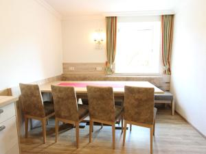 a dining room with a table and chairs at Modern Apartment in Fieberbrunn with Terrace in Fieberbrunn