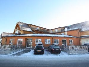 two cars are parked in front of a house at Vogue Apartment in Sankt Margarethen im Lungau near Ski Lift in Sankt Margarethen im Lungau