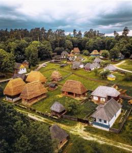 an aerial view of a village with houses with thatched roofs at Urban Sunset Apartment in Sibiu +20 photos