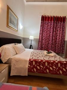 ローマにあるAffitacamere Radiのベッドルーム1室(赤いカーテン付きのベッド1台付)