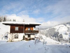 a log cabin in the snow on a mountain at Apartment in Sankt Johann im Pongau near Ski Area in Wagrain