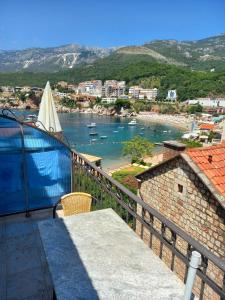 a balcony with a view of a body of water at Apartments Mitrovići Miločer in Sveti Stefan