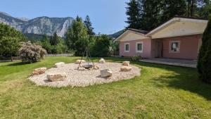 a fire pit in a yard in front of a house at Wülde Hoamat in Eisenerz