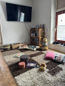 a living room with toys on the floor and a flat screen tv at Gutsherrenwohnung in Süderholz
