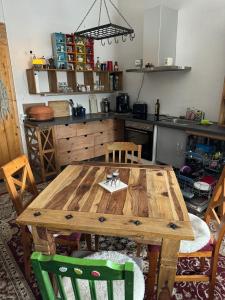a kitchen with a wooden table and chairs at Gutsherrenwohnung in Süderholz