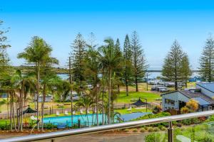 an aerial view of a resort with a pool and palm trees at Tasman Towers 5 3 Munster Street in Port Macquarie