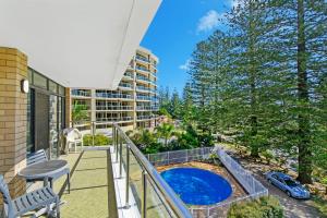 a balcony with a pool and a table and chairs at Tasman Towers 5 3 Munster Street in Port Macquarie