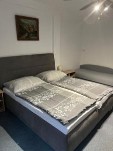 a large bed sitting in a room with at Penzión Vilo in Bratislava