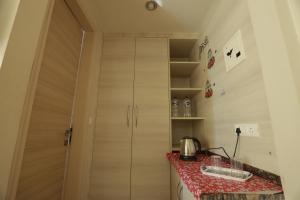 a kitchen with a cabinet and a counter with a table at The Grand View Studio in Vrindāvan