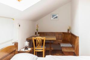 a dining room with a table and two chairs at Bed and Breakfast Mili Vrh in Kamnik