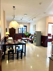 a kitchen and living room with a table and chairs at Con Dao Tan Son Nhat Hotel in Con Dao