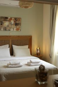a bedroom with a bed with two towels on it at Aithra -Agios Petros Andros in Gavrio