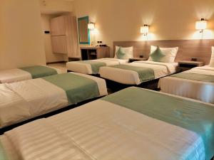 A bed or beds in a room at WATERWORLD HOTEL