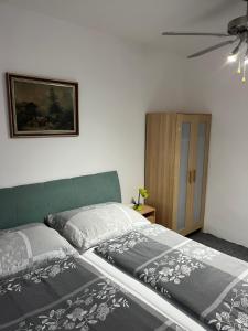 a bedroom with two beds and a ceiling fan at Penzión Vilo in Bratislava