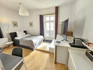 a bedroom with a bed and a desk with a computer at Stadtapartment HEF in Bad Hersfeld