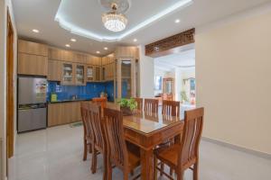 Una cocina con una mesa y sillas de madera. en NATA-Căn hộ du lịch Nha Trang, en Nha Trang