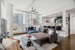 a living room with a couch and a table at Upscale 2BR Condo - King Bed - Stunning Views in Calgary