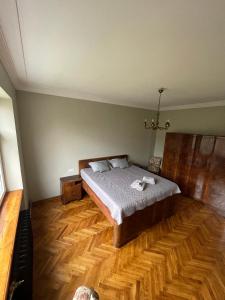 um quarto com uma cama e piso em madeira em Vintage apartment Ranne em Riga