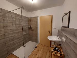 W łazience znajduje się prysznic i umywalka. w obiekcie Ferienwohnung am Wald 