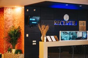 a reception area of a hotel with a sign that reads negative at Hotel Del Mar Venus in Venus