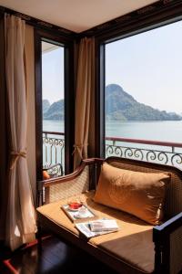 a room with a table and two large windows at Indochine Cruise Lan Ha Bay Powered by ASTON in Ha Long