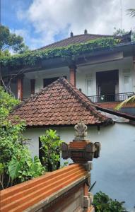 una casa con techo de azulejos encima en Yobi House, en Ubud