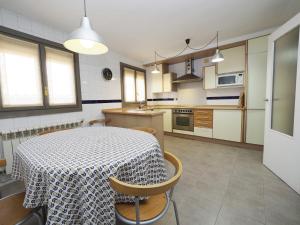 a kitchen with a table and some chairs and a table and a kitchen at Plaza Mercadal, Tudela in Tudela