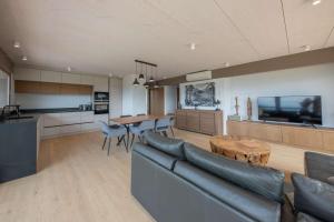 a living room with a couch and a table at Appartement UBAC in Rovagny
