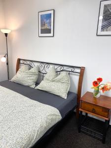 a bedroom with a bed with pillows and a table at Ubytování Šantovka in Olomouc