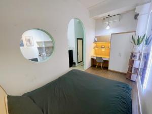 a bedroom with a bed and a mirror on the wall at Promotion Quoc Tu Giam 202 in Hanoi