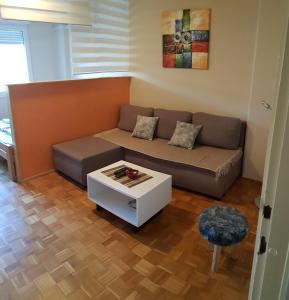 a living room with a couch and a table at Apartman Vanja in Belgrade